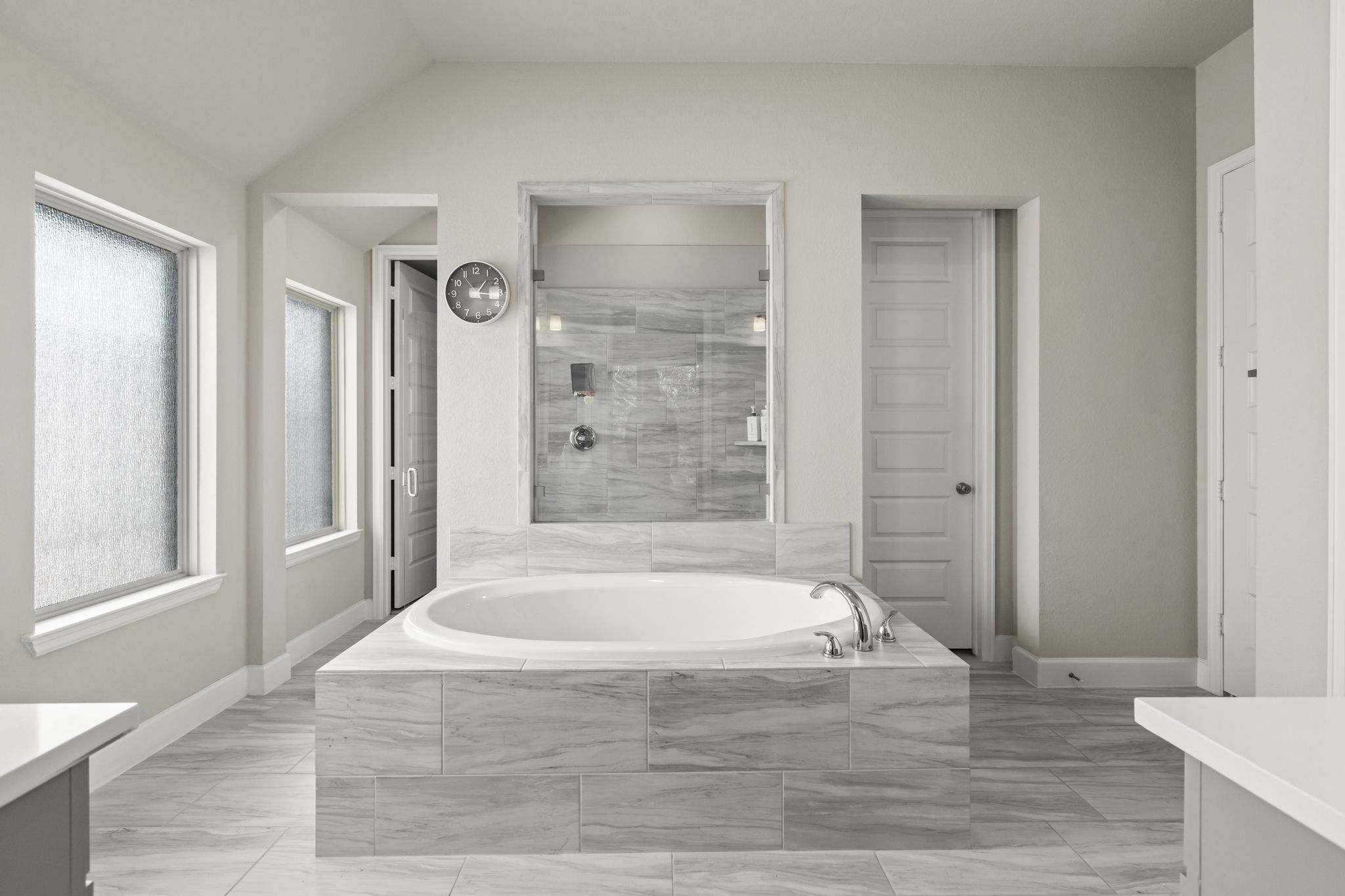 313 Terrene Trail Georgetown, TX 78628 - Photo 17 of 40 Full bath with vanity, a shower stall, a bath, and light marble finish flooring