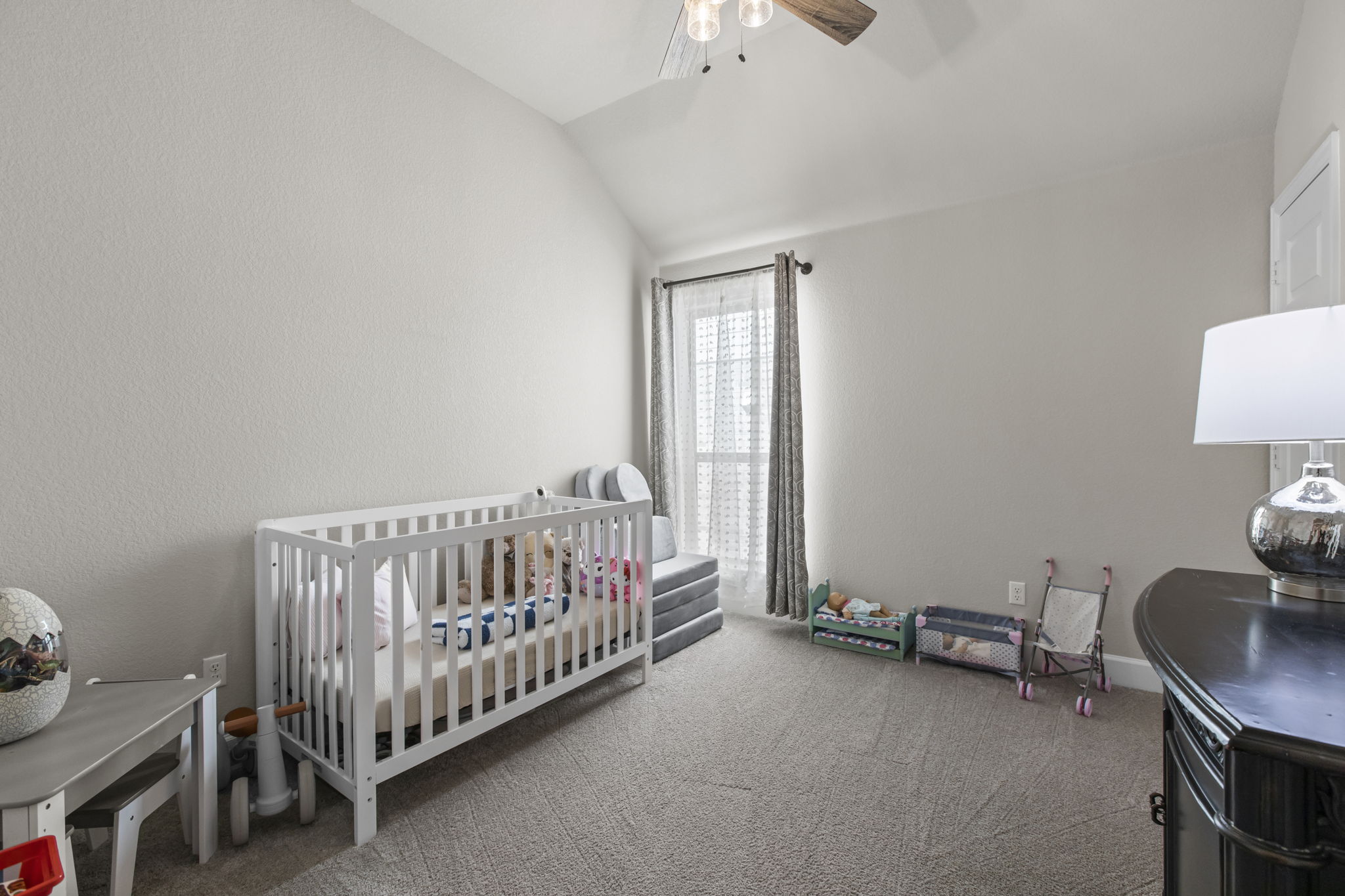313 Terrene Trail Georgetown, TX 78628 - Photo 19 of 40 Bedroom with a crib, carpet flooring, ceiling fan, and lofted ceiling