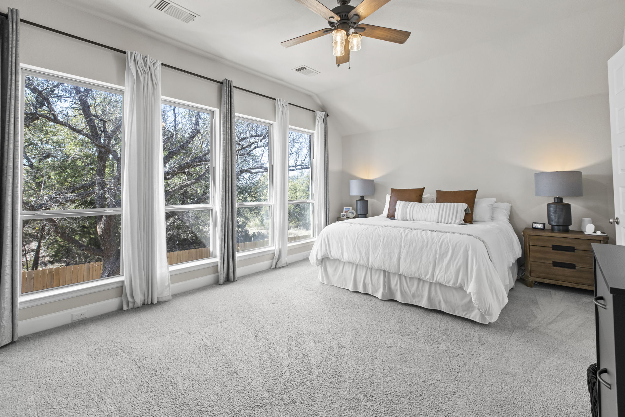 313 Terrene Trail Georgetown, TX 78628 - Photo 20 of 40 Bedroom with vaulted ceiling, light colored carpet, and a ceiling fan