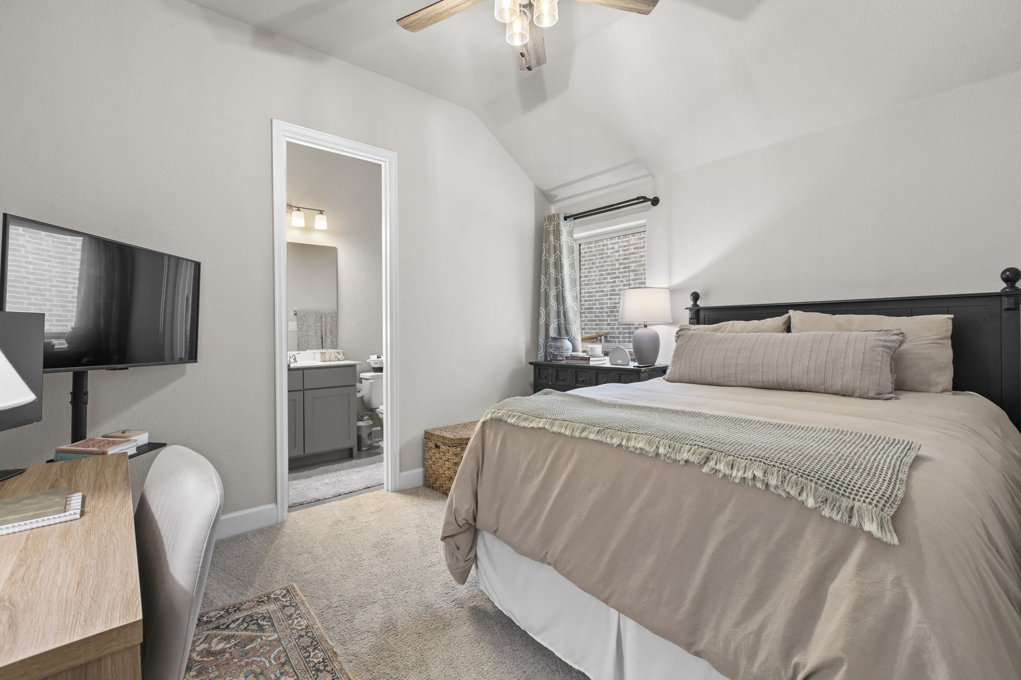 313 Terrene Trail Georgetown, TX 78628 - Photo 23 of 40 Bedroom with light colored carpet, lofted ceiling, a ceiling fan, and ensuite bath