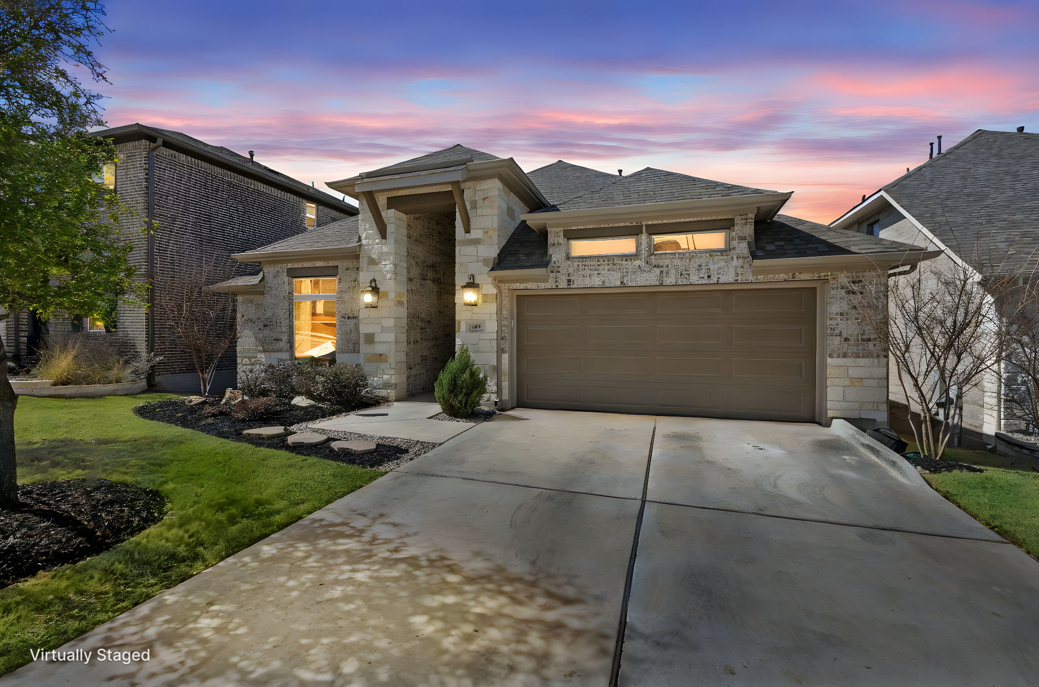 313 Terrene Trail Georgetown, TX 78628 - Photo 3 of 40 View of front of house featuring an attached garage, concrete driveway, brick siding, a front lawn, and stone siding