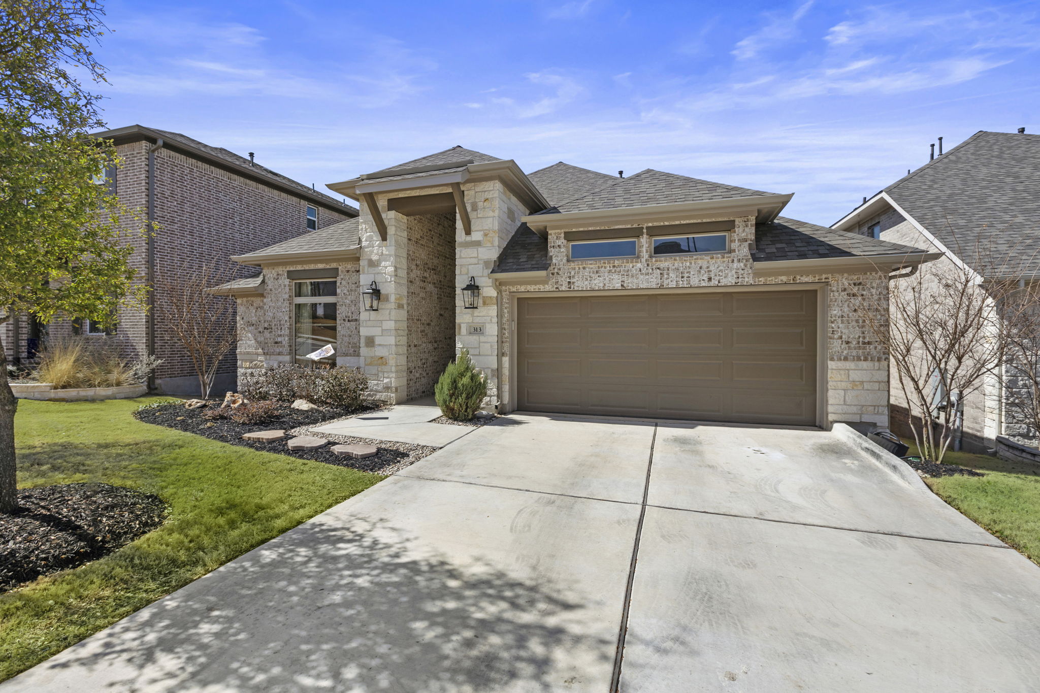 313 Terrene Trail Georgetown, TX 78628 - Photo 5 of 40 View of front of house with driveway, an attached garage, a front yard, and a shingled roof
