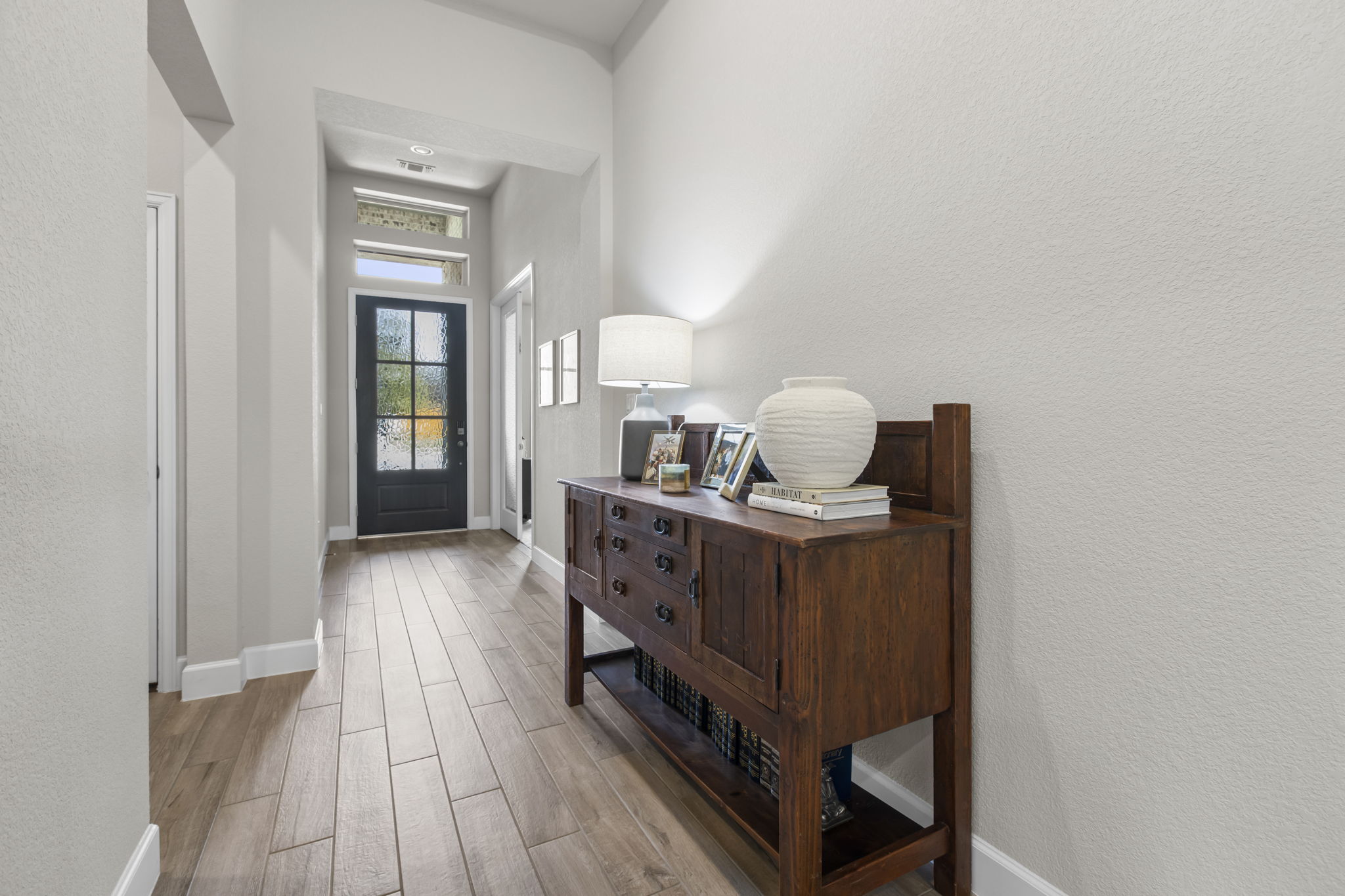 313 Terrene Trail Georgetown, TX 78628 - Photo 7 of 40 Entryway featuring wood tiled floors and a textured wall