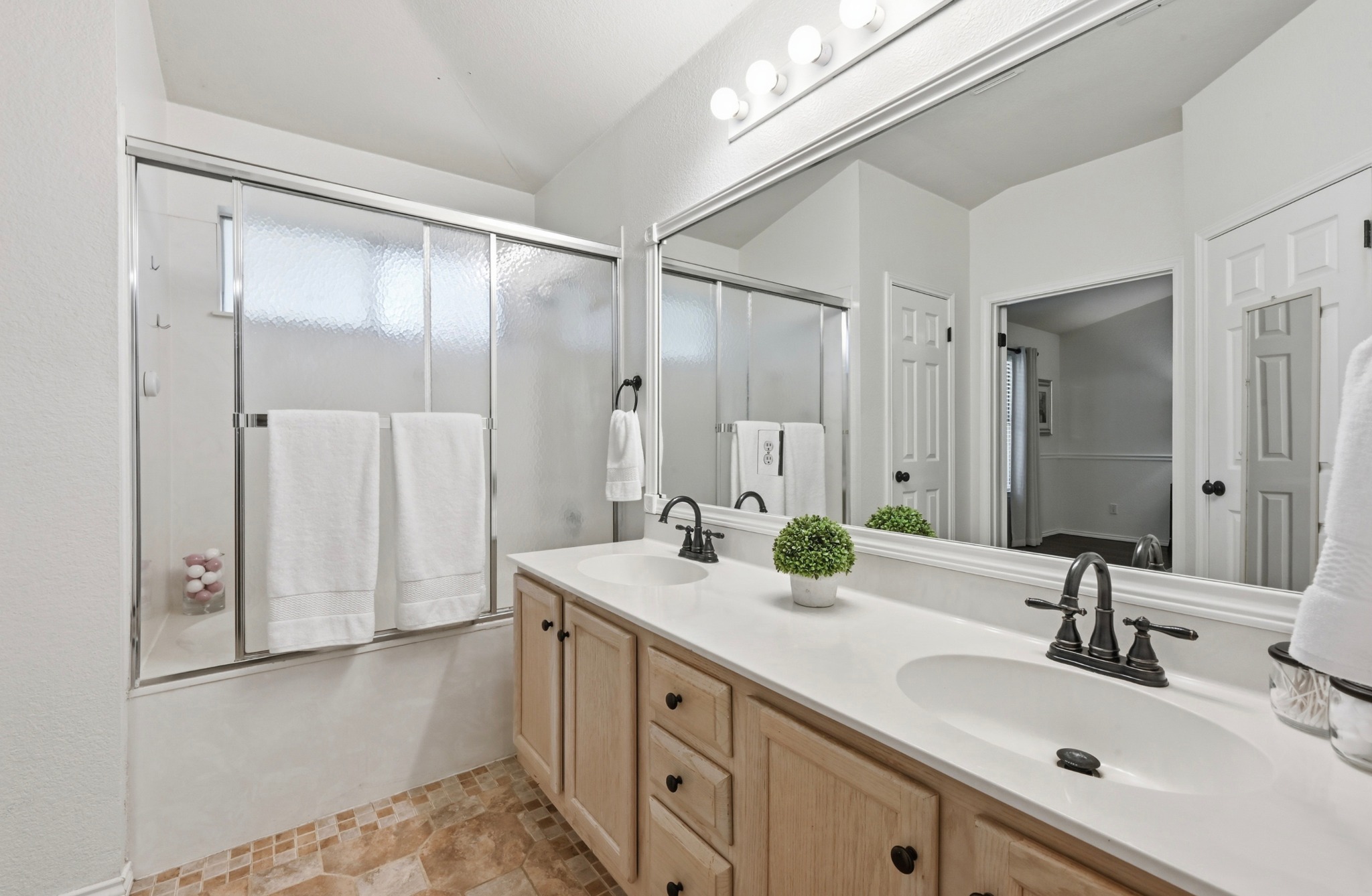 1409 Knoll Ridge Drive Cedar Park, TX 78613 - Photo 17 of 30 Double vanity and a full shower-over-tub combination highlight this primary bathroom.