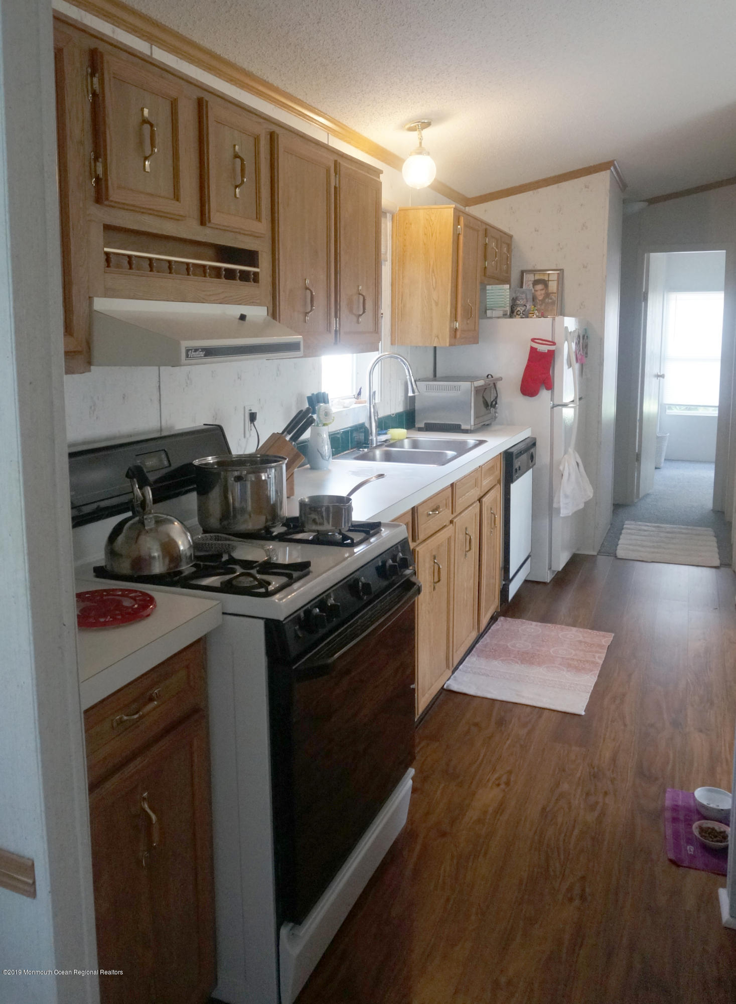 112 Woody Road Freehold, NJ 07728 - Photo 8 of 28 a kitchen with stainless steel appliances granite countertop a stove a sink and a microwave
