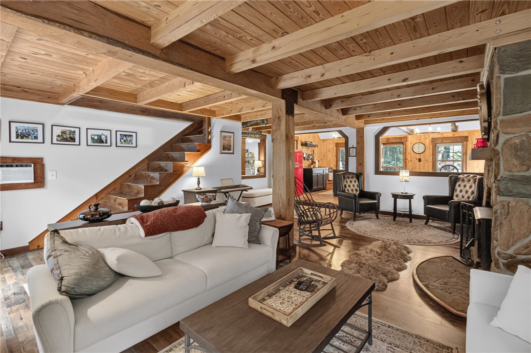 130 Maggie Rufus Lane Westminster, SC 29693 - Photo 31 of 50 Exposed wood beams and a stone fireplace create a warm, inviting living space.
