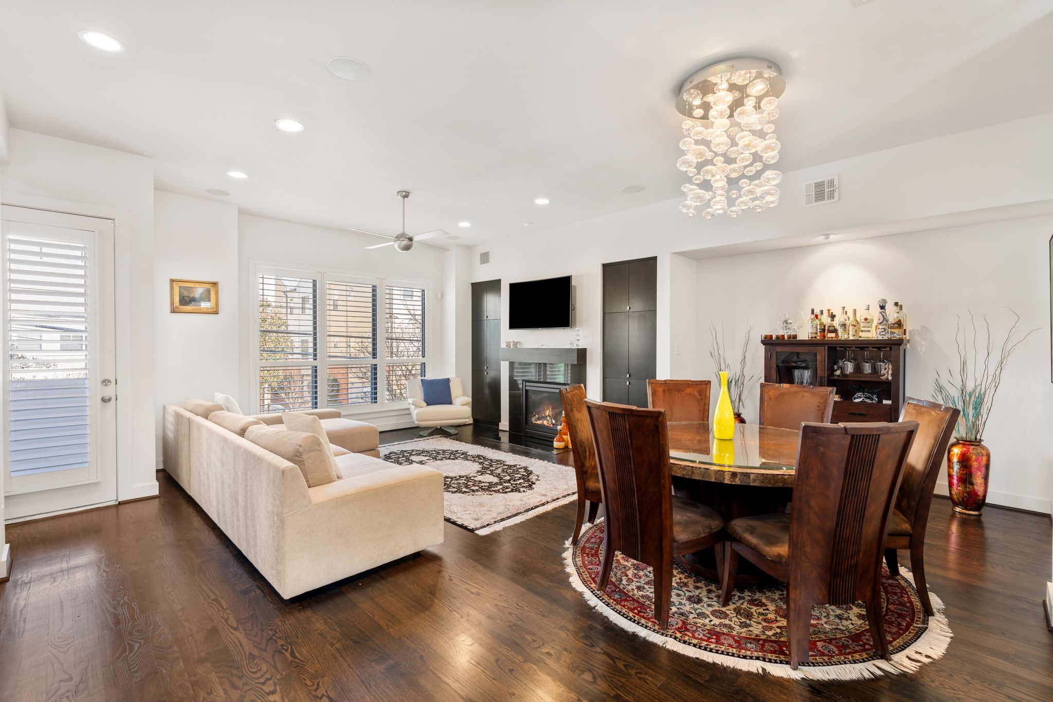 5911 Rose Street Houston, TX 77007 - Photo 33 of 35 Thoughtfully designed floor plan featuring rich hardwood floors and an open-concept layout that flows seamlessly for both everyday living and entertaining. Privacy-shuttered windows throughout provide an abundance of natural light while maintaining comfort and discretion. A door off the living space leads to a charming second-floor balcony.