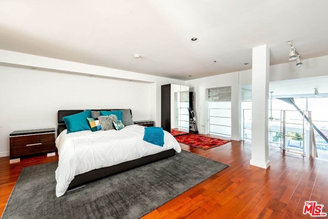 615 Hampton Drive, Unit A109 Venice, CA 90291 - Photo 8 of 12 a bedroom with a bed and wooden floor