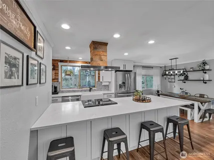 a kitchen with a table chairs and stove