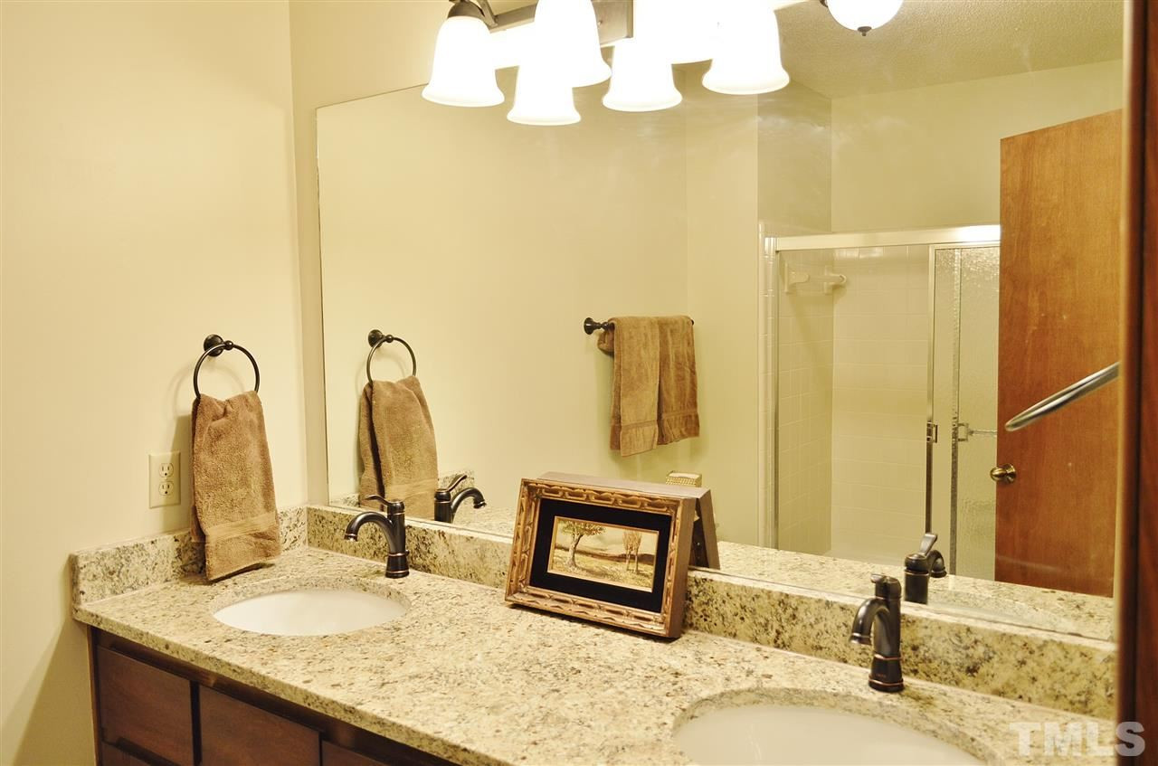 5200 Caber Road Raleigh, NC 27613 - Photo 22 of 25 The hall bath upstairs has a new granite counter and under mount sink, new faucets, new lighting, and new tile floor. Upstairs Hall Bath
