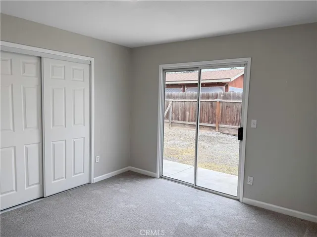 an empty room with sliding glass door