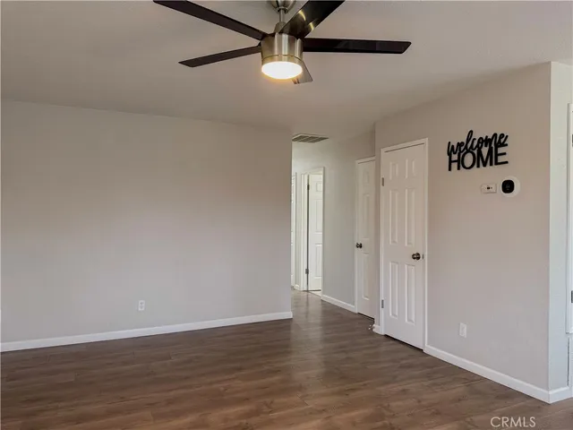 a view of a room with wooden floor