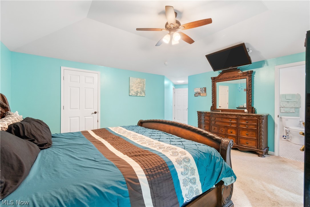 3255 Old Weymouth Road Medina, OH 44256 - Photo 16 of 31 Carpeted bedroom featuring ceiling fan, ensuite bath, and lofted ceiling