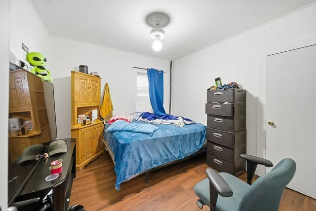 a bedroom with a bed dresser and a window