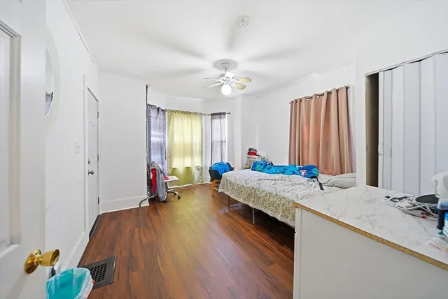 a bed room with a bed window and a chandelier