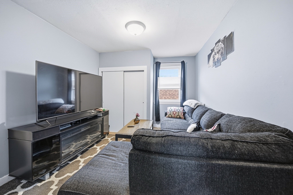 94 Sheridan Street Lynn, MA 01902 - Photo 21 of 33 a living room with furniture and a flat screen tv