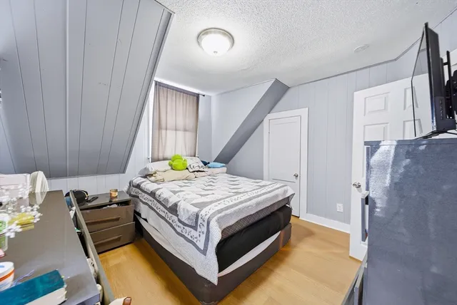 a bed sitting in a bedroom next to a cabinet