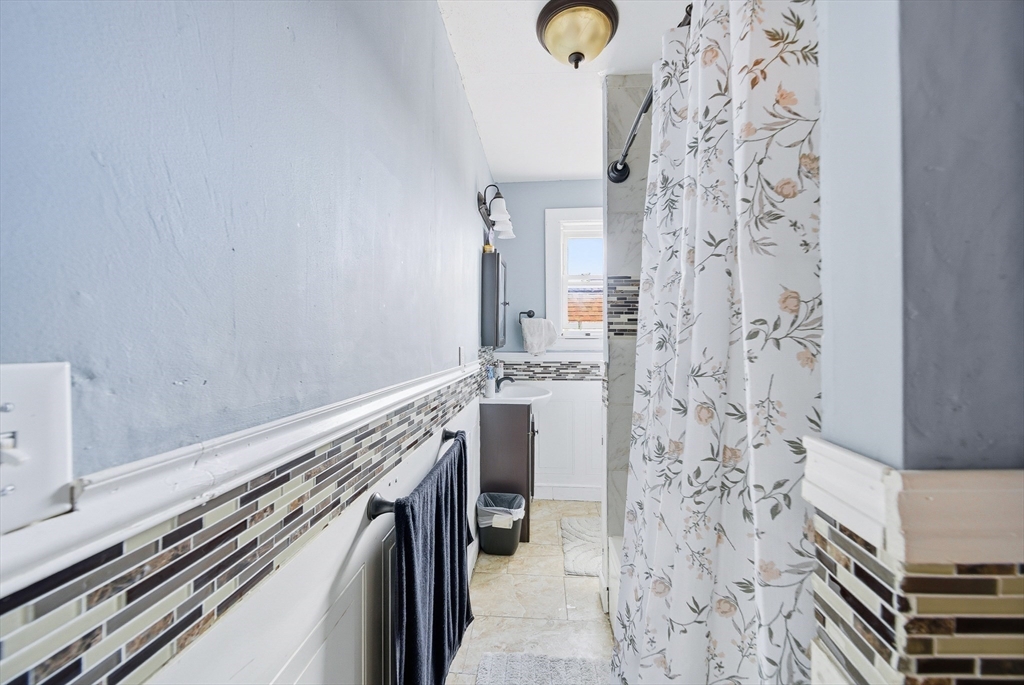 94 Sheridan Street Lynn, MA 01902 - Photo 25 of 33 a bathroom with a shower and mirror