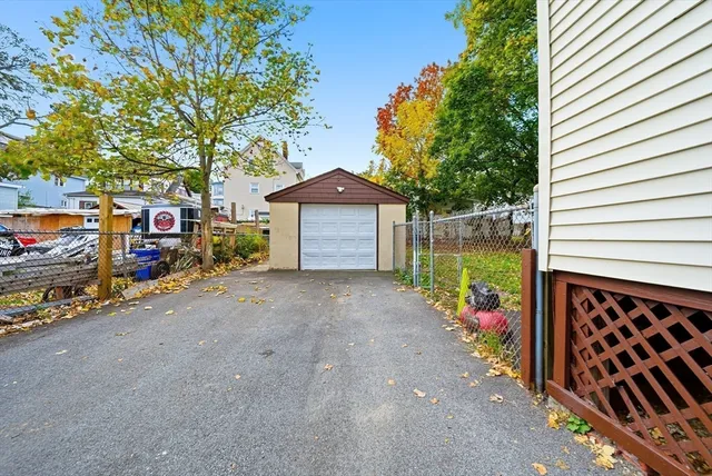 a front view of a house with a garden and mountain view