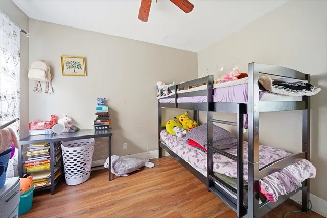 a bedroom with baby bed and wooden floor