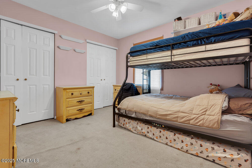 25 Concord Circle Howell, NJ 07731 - Photo 14 of 26 a bedroom with a bed and a chandelier