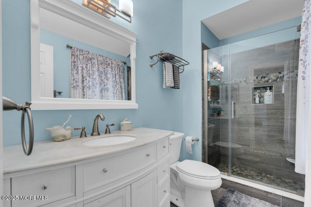 25 Concord Circle Howell, NJ 07731 - Photo 16 of 26 a bathroom with a sink a toilet and shower