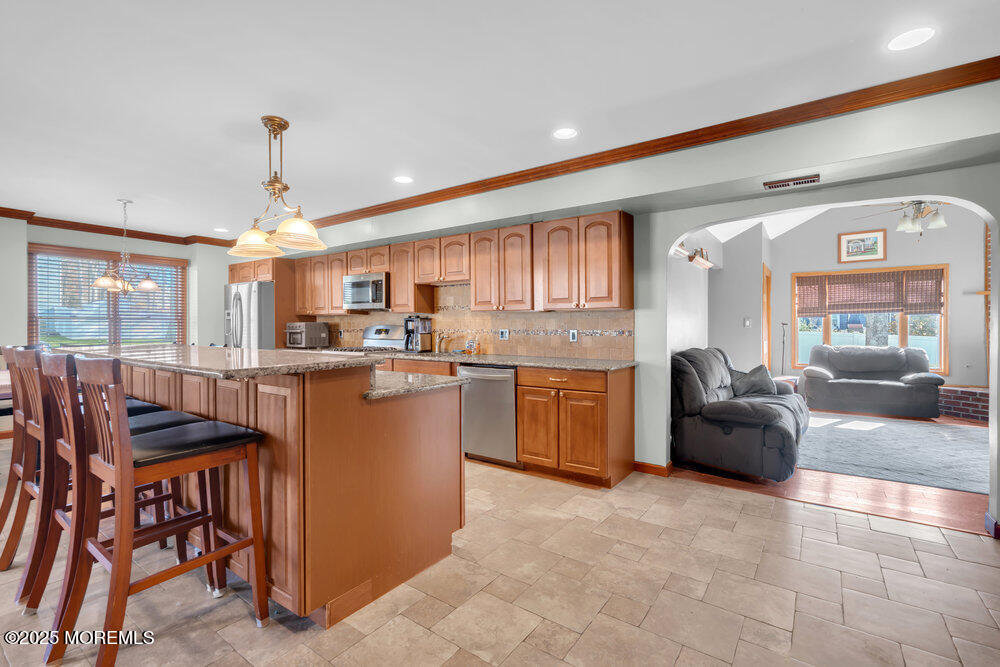 25 Concord Circle Howell, NJ 07731 - Photo 7 of 26 a kitchen with a table chairs refrigerator and cabinets