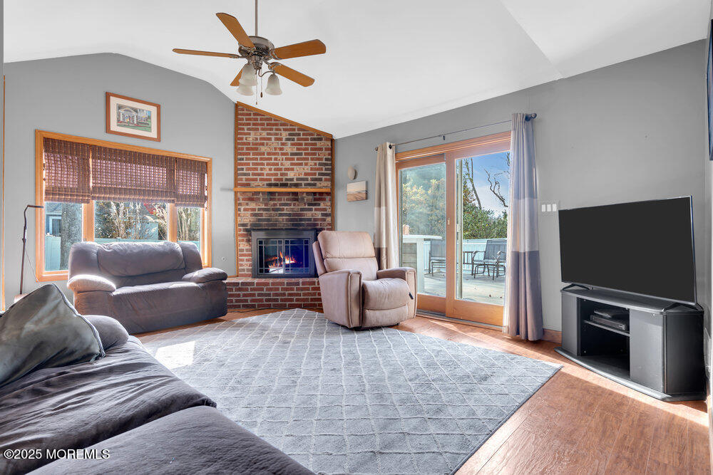 25 Concord Circle Howell, NJ 07731 - Photo 8 of 26 a living room with furniture a flat screen tv and a large window
