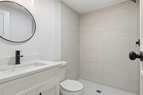 a bathroom with a sink a toilet and a mirror