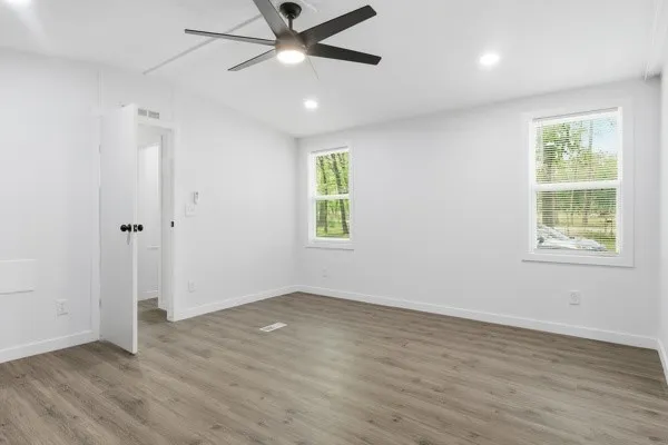 wooden floor in an empty room with a window