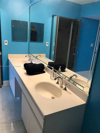 a bathroom with a sink and a large mirror