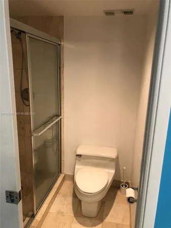 a bathroom with a toilet and a shower