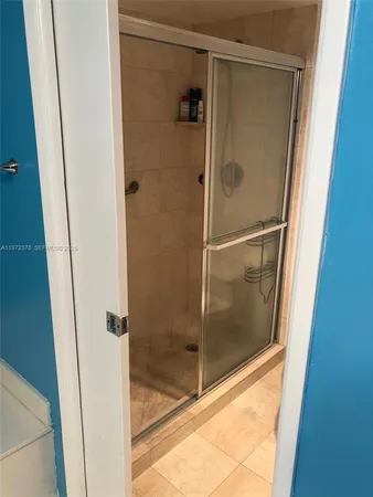 a bathroom with a glass shower door