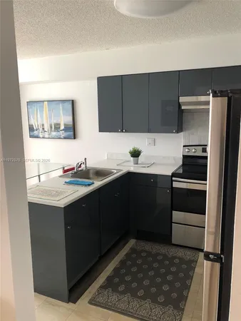 a kitchen with a sink stove and refrigerator