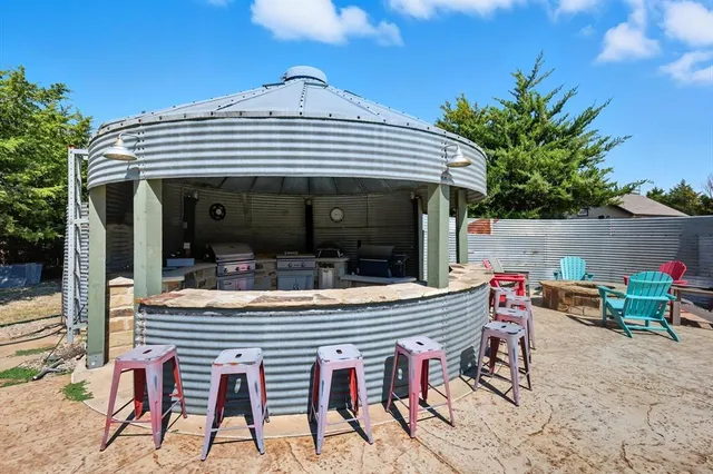 a view of house with a table and chairs in patio