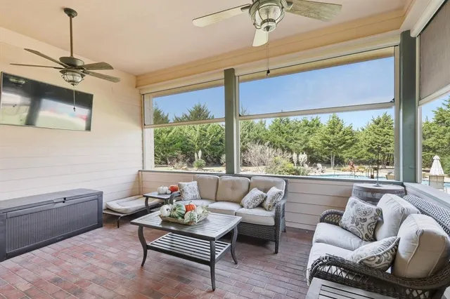 a view of a swimming pool and lounge chairs in back yard of the house