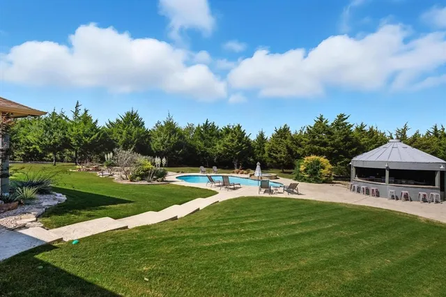 a view of a swimming pool with lounge chairs