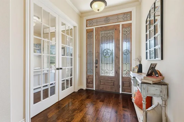 a kitchen with stainless steel appliances white cabinets stove and wooden floor