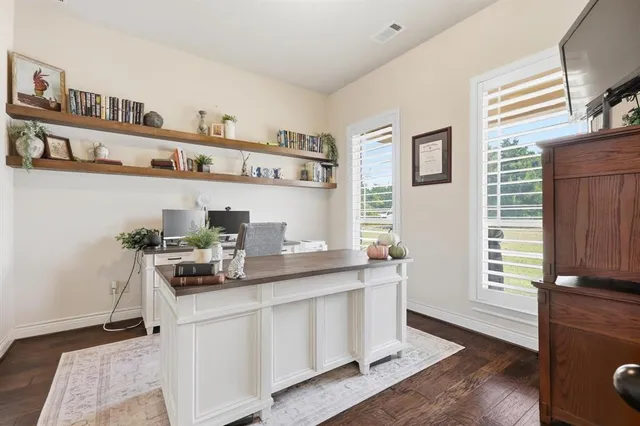 a living room with stainless steel appliances kitchen island granite countertop wooden floors and a view of kitchen