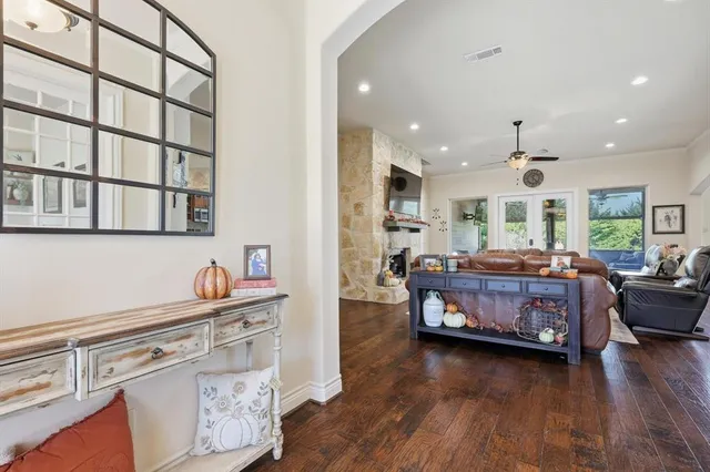 a living room with fireplace furniture and a wooden floor