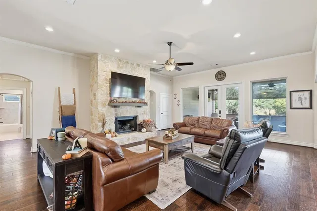 a living room with furniture kitchen view and a window