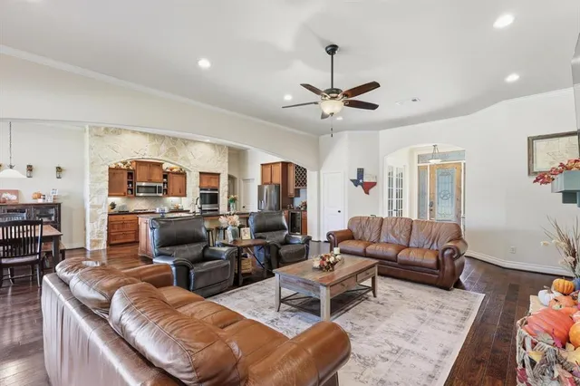 a kitchen with granite countertop a refrigerator and a stove top oven