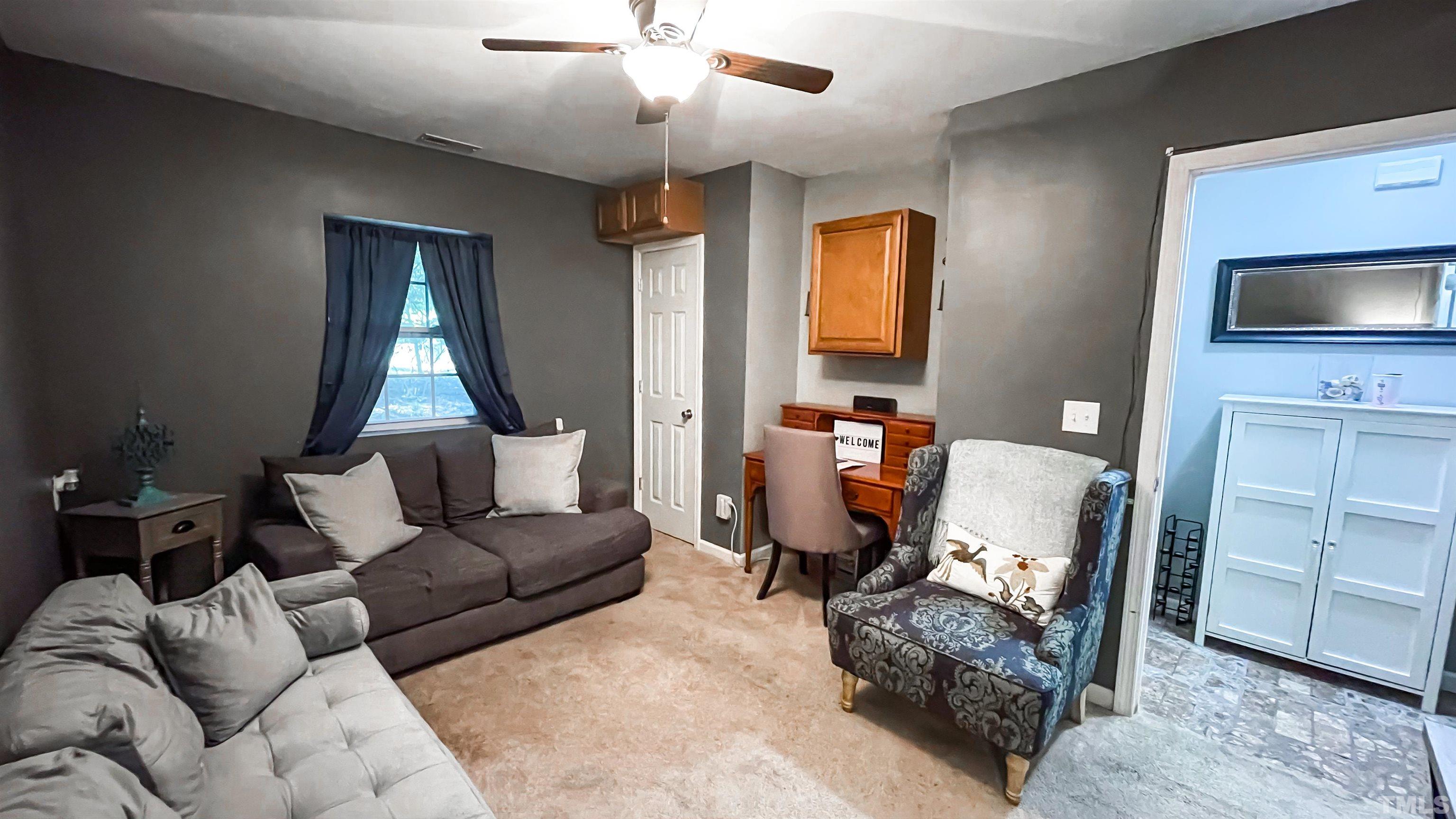 2414 Dorety Place Raleigh, NC 27604 - Photo 22 of 29 a living room with furniture a flat screen tv and a window