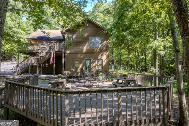 a view of house with a yard and a garage