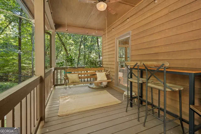 a living room with patio furniture and a potted plant