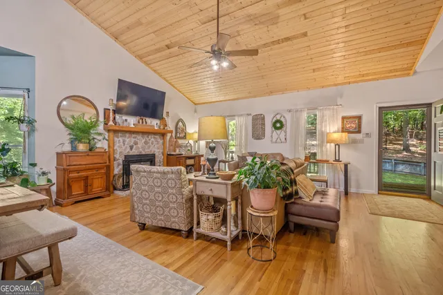 a living room with furniture a fireplace and a flat screen tv