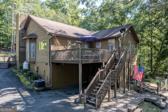 a view of a house with backyard and sitting area