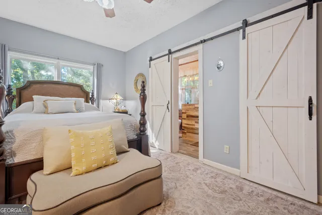a view of a patio with a table and chairs under an umbrella