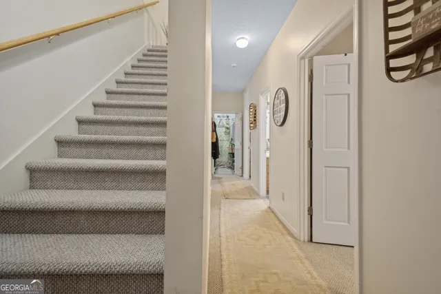 an aerial view of residential houses with outdoor space and trees