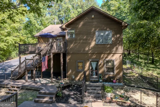 a view of a roof deck with chair and wooden floor